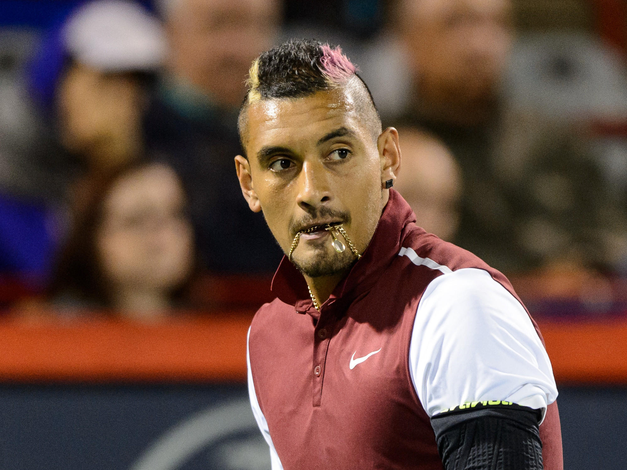 Tennis bad boy Nick Kyrgios bites his chain during his Rogers Cup match against Stan Wawrinka