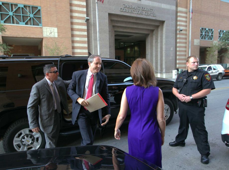 Texas Attorney Gen. Ken Paxton second left arrives at the Tarrant County Courthouse for a hearing on his felony securities indictment Thursday Aug. 27 2015 in Fort Worth Texas. Paxton pleaded not guilty Thursday to charges alleging that he defraude