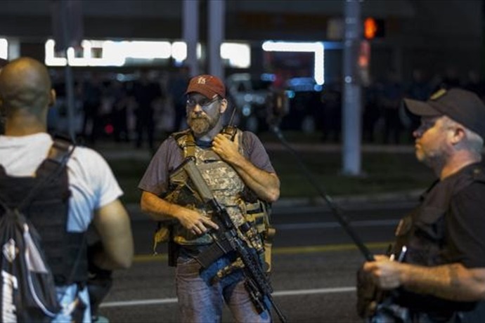 The Latest on Ferguson: Police say nearly 2 dozen arrested during protest