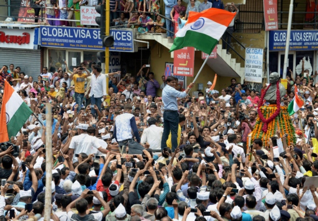 The arrest of Patidar leader Hardik Patel holding flag sparked further rioting across Gujarat leading to a curfew