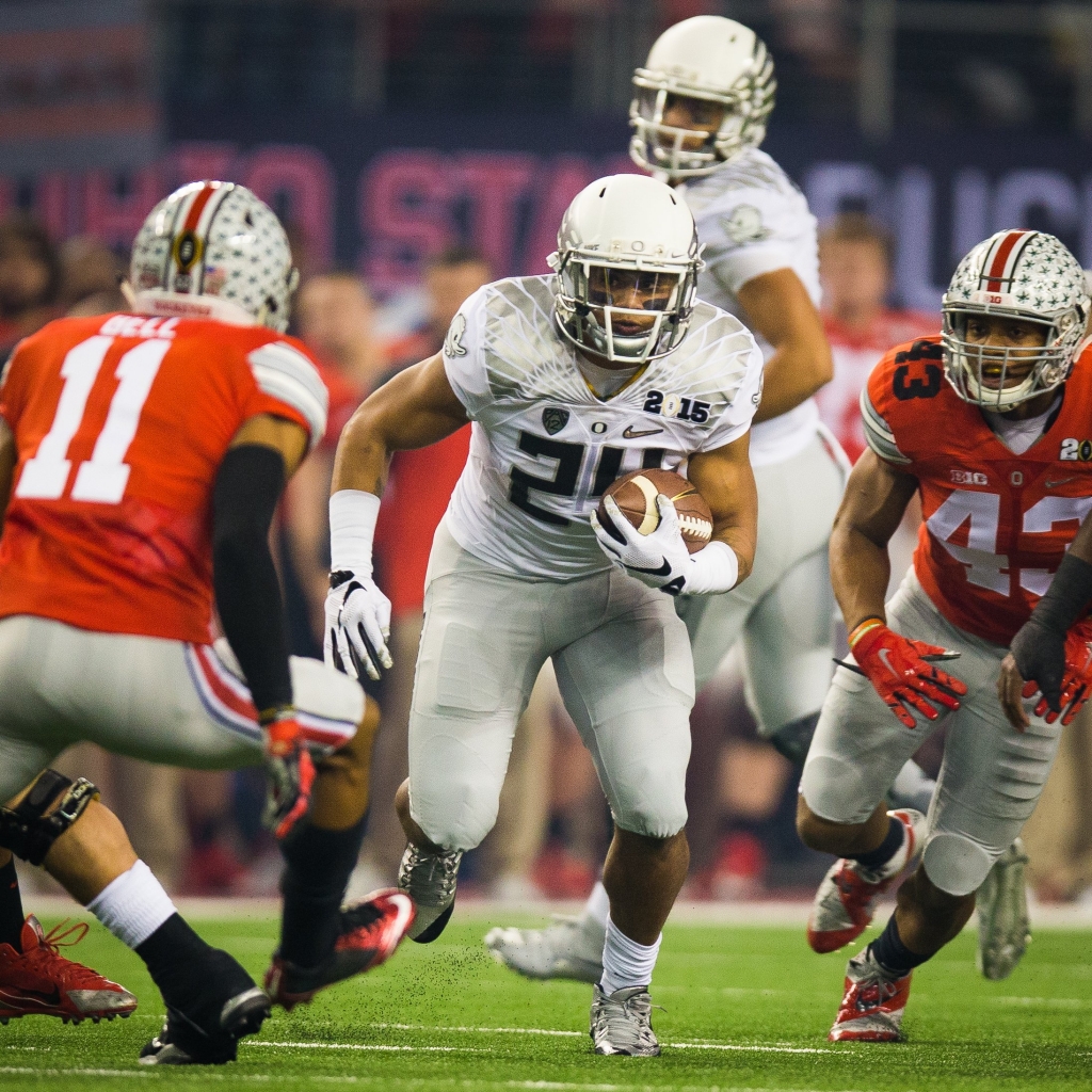 Thomas Tyner attempts to evade Ohio State tacklers in the national championship game on Jan. 14 at AT&T Stadium in Arlington Texas