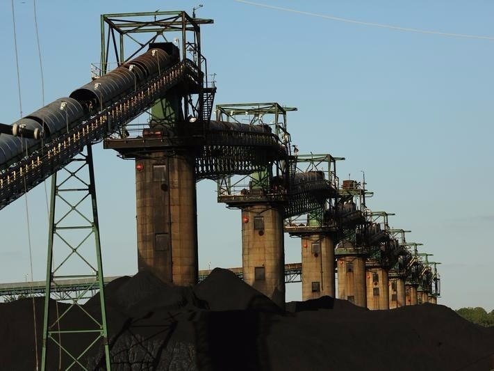 Coal is stacked at the base of coal loaders along the Ohio River in Ceredo West Virginia