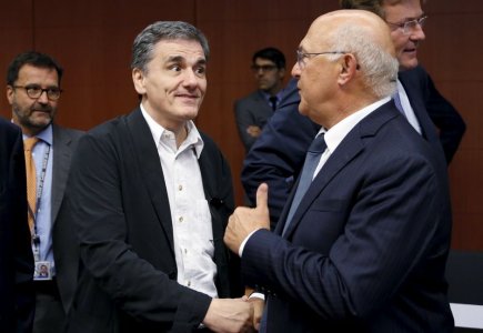 Greek Finance Minister Euclid Tsakalotos listens his French counterpart Michel Sapin during a euro zone finance ministers meeting in Brussels Belgium