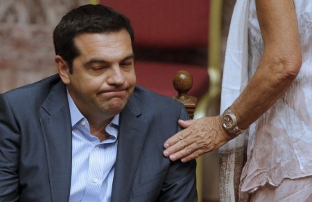 Greek Prime Minister Alexis Tsipras reacts as he attends a parliamentary session in Athens Greece