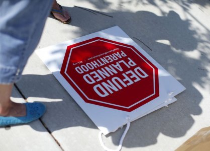 Protesters stand on a sidewalk outside a Planned Parenthood clinic in Vista California