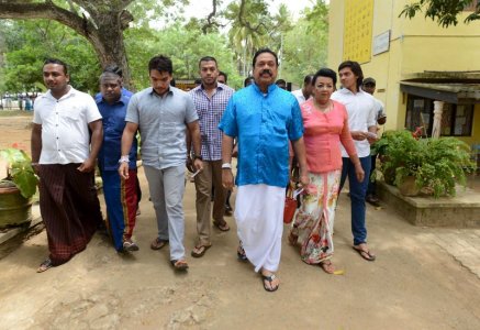 Sri Lanka's former President Mahinda Rajapaksa arrives at a polling station during the general election in Medamulana