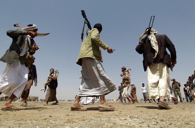 Tribal gunmen loyal to the Houthi movement walk holding their weapons during a gathering against the Saudi-led intervention in the country in the Bani al Harith area north of the capital Sanaa on Aug. 6 2015