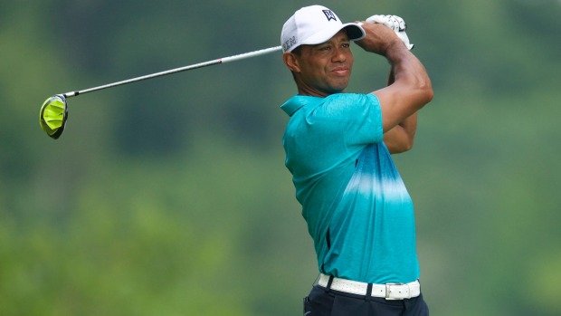 Tiger Woods watches his drive from the tee on the 12th hole in the third round of the Quicken Loans National golf tournament at Robert Trent Jones Golf Club