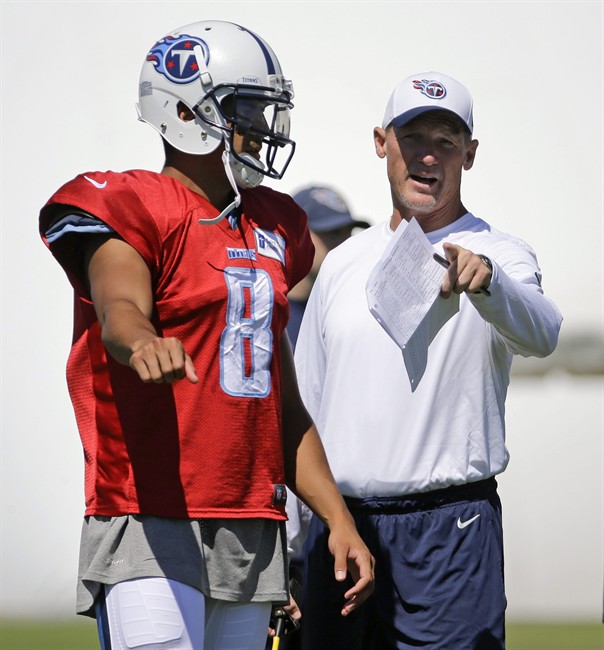 Tennessee Titans head coach Ken Whisenhunt right talks with quarterback Marcus Mariota during NFL football training camp Sunday Aug. 2 2015 in Nashville Tenn