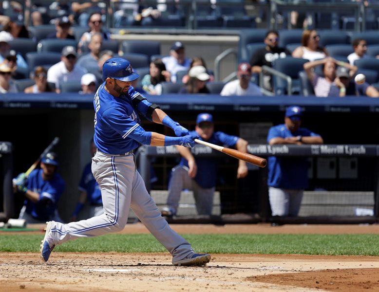 Toronto Blue Jays&#039 Jose Bautista hits a solo home run during the fourth inning of the baseball game against the New York Yankees at Yankee Stadium