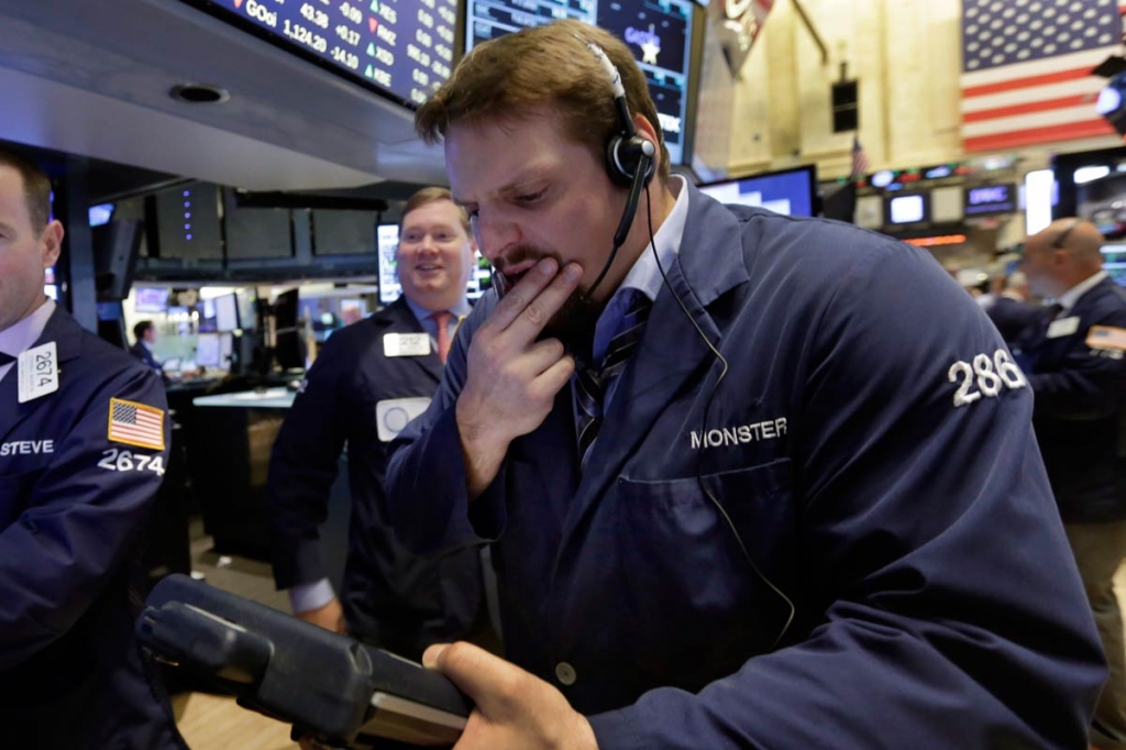 Trader Michael Milano right works on the floor of the New York Stock Exchange Wednesday Aug. 26 2015