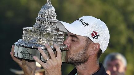 Troy Merritt kisses the trophy after winning the Quicken Loans International