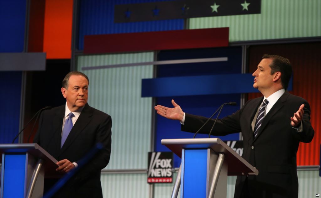 Sen. Ted Cruz R-Texas speaks as former Arkansas Gov. Mike Huckabee left listens during the first Republican presidential debate Cleveland IN Aug. 6 2015 in Cleveland