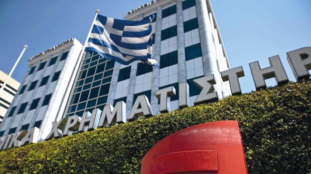 A Greek flag flutters outside the Athens Stock Exchange