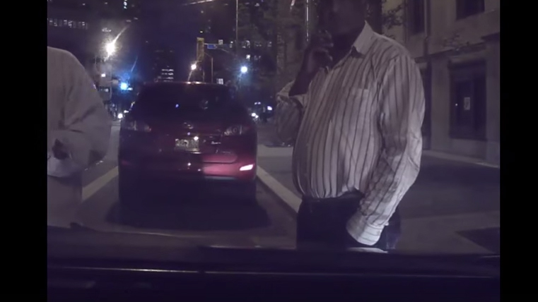 Two alleged taxi drivers block an UberX from leaving with his passenger Aug 12 2015. You Tube screengrab