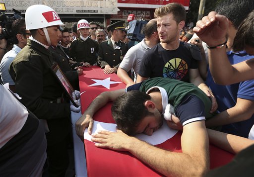 A relative cries over the Turkish flag-draped coffin of Turkish soldier Kagan Kandemir during his funeral in the town of Civril Turkey Friday