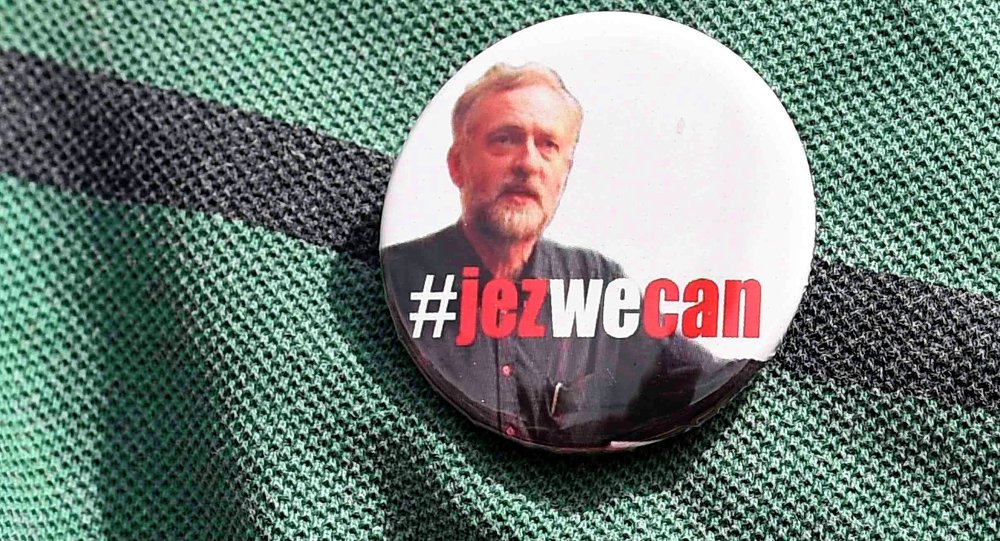 A supporter wears a campaign badge as British Labour Party politician Jeremy Corbyn arrives for a community meeting in north Lond