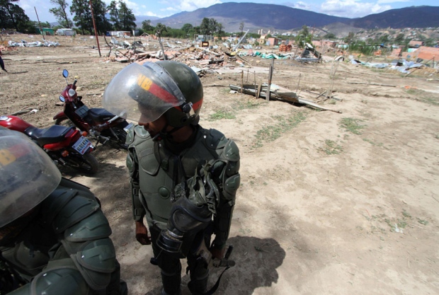 Venezuelan soldiers patrol among the rubble of houses of deported Colombians in the border city of San Antonio