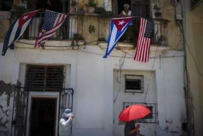 Cuban and U.S. flags hang from a resident's balcony on the day the U.S. opened its embassy in Havana Cuba Friday Aug. 14 2015. U.S. Secretary of S