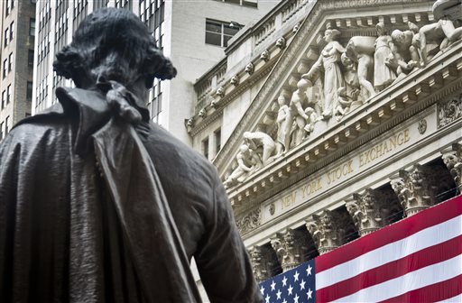 Federal Hall's George Washington statue stands near the flag-covered pillars of the New York Stock Exchange Wednesday