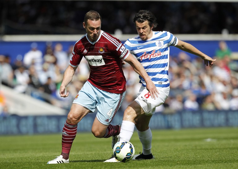 West Ham United's English midfielder Kevin Nolan vies with then Queens Park Rangers’ English midfielder Joey Barton