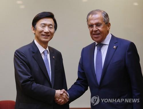 Foreign Minister Yun Byung-se shakes hands with his Russian counterpart Sergey Lavrov ahead of a bilateral meeting in Kuala Lumpur Malaysia on Aug. 5 2015