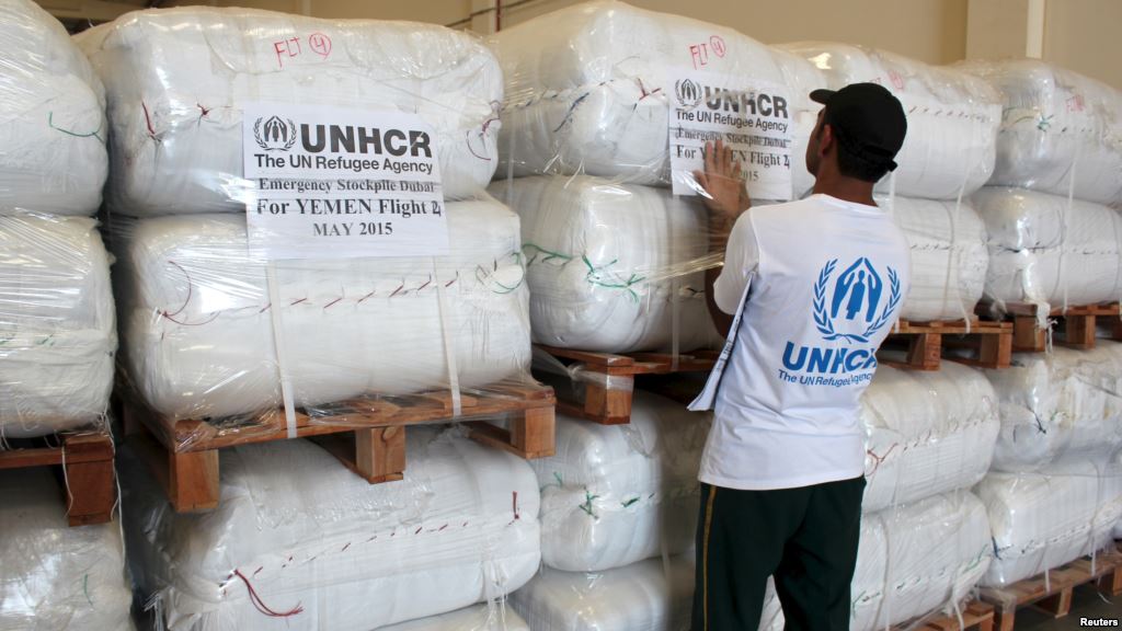 A UNHCR employee arranges aid at the Dubai International Humanitarian city in Dubai United Arab Emirates before shipping them to Yemen