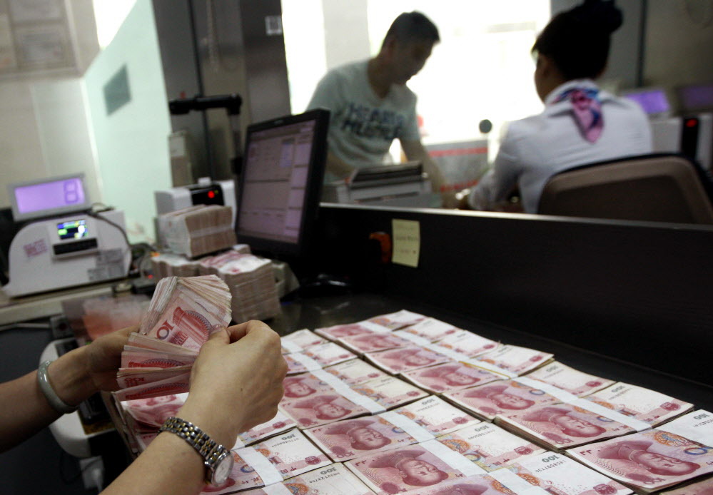 What is China doing with its currency, and why?