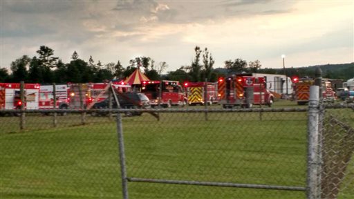 Officers surround the scene of a tent collapse in Lancaster N.H. Monday Aug. 3 2015. Authorities say the circus tent collapsed when a severe storm raked the New Hampshire fairground