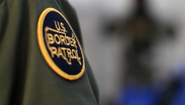 A logo patch is shown on the uniform of a U.S. Border Patrol agent