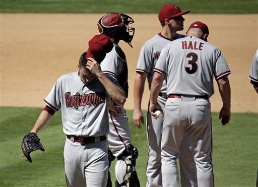 Arizona Diamondbacks starting pitcher Patrick Corbin left wipes his face as he leaves the game after giving up two runs to the Los Angeles Dodgers during the fifth inning of a baseball game in Los Angeles Thursday Sept. 24 2015. (AP