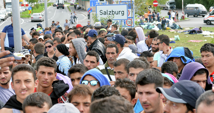 Refugees wait on a bridge after police stopped them at the border between Austria and Germany in Salzburg Austria Thursday Sept. 17 2015