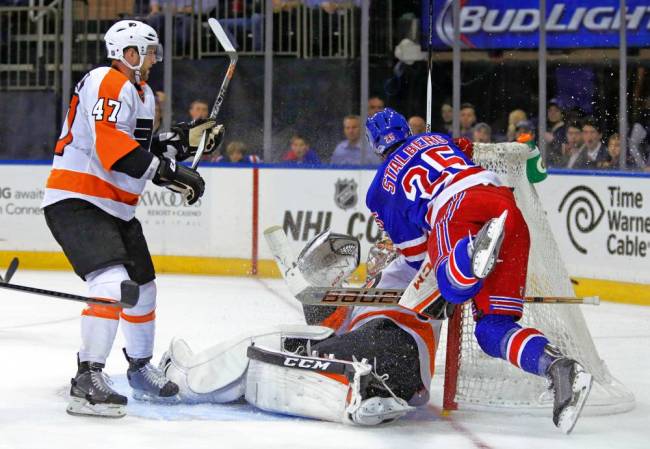 Rangers forward Viktor Stalberg right crashes into Flyers goaltender Steve Mason during the second period Monday