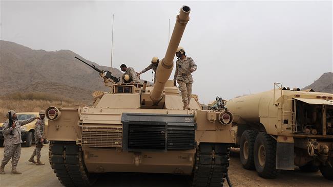 Saudi soldiers are seen on top of a tank deployed at the Saudi Yemeni border in Saudi Arabia's southwestern Jizan region