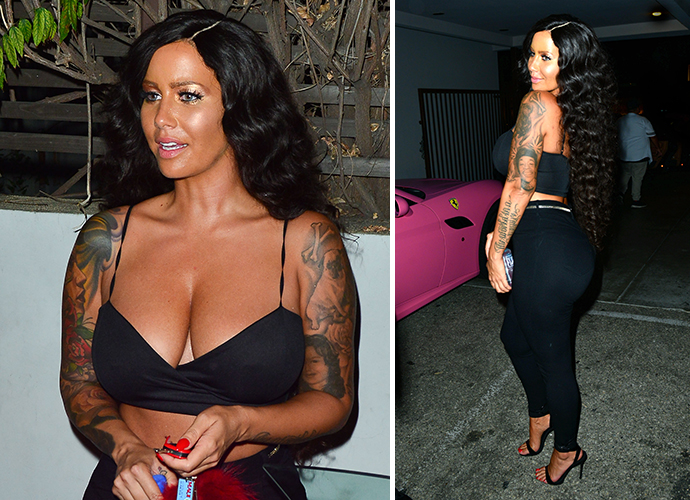 Amber Rose looks unrecognizable with dark tan and long black hair