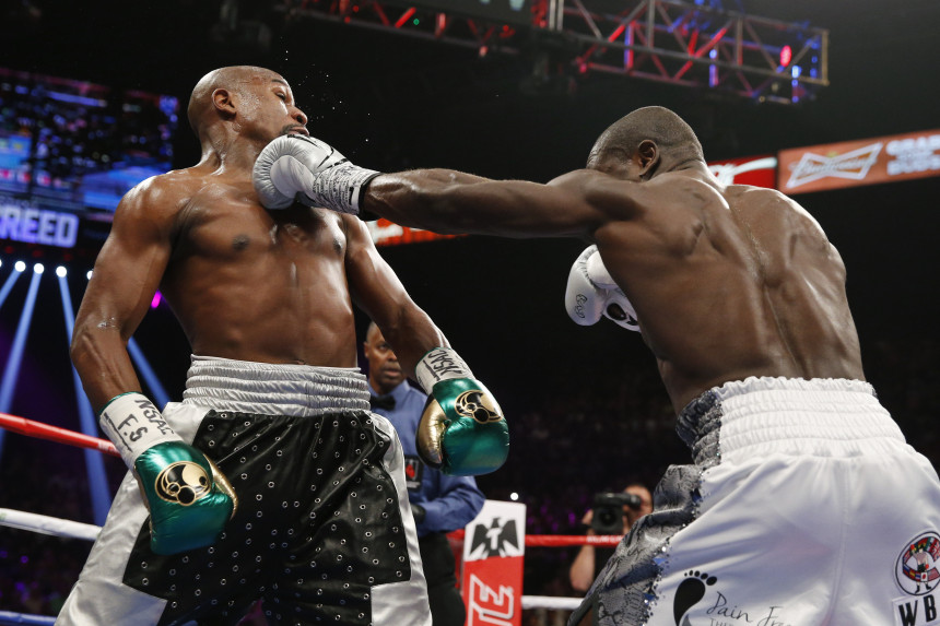 Andre Berto right hits Floyd Mayweather Jr. during their welterweight title boxing bout Saturday Sept. 12 2015 in Las Vegas. AP