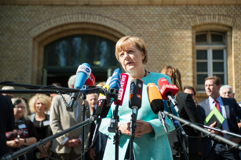 German Chancellor Angela Merkel makes a statement after a visit at a branch of the Federal Office for Migration and Refugees and a camp for asylum-seekers in Berlin