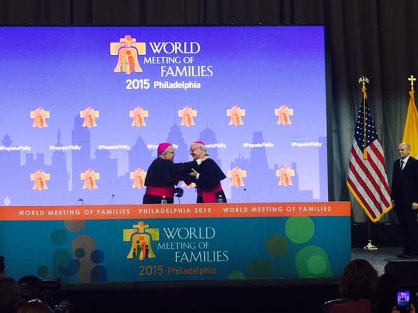 Archbishop Charles Chaput and Archbishop Vincenzo Paglia embrace at the start of the World Meeting of Families