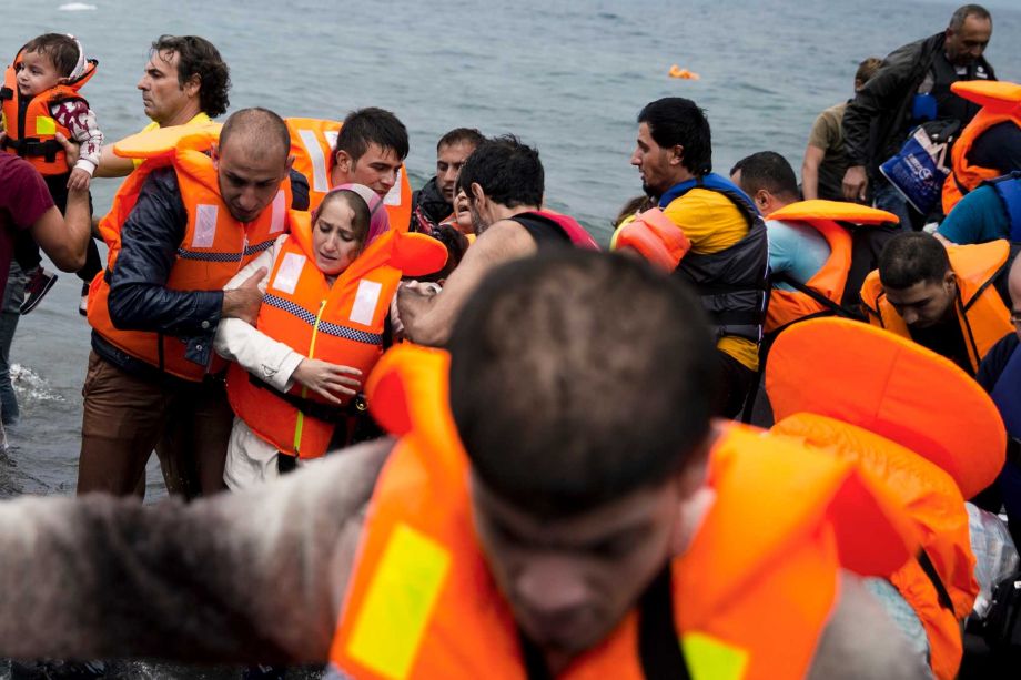 Syrian refugees arrive on the shores of the Greek island of Lesbos after crossing the Aegean Sea from Turkey on a inflatable dinghy, Tuesday Sept. 22 2015. More than 260,000 asylum-seekers have arrived in Greece so far this year most reaching the cou