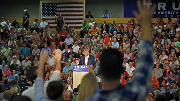 Audience members raise their hands during a question and answer session with Republican presidential candidate Donald Trump on Thursday