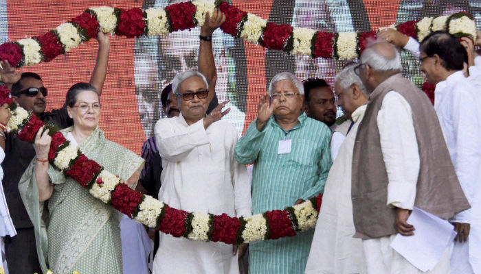 Congress President Sonia Gandhi being welcomed with a garland along with Bihar chief Minister and Senior JD Leader Nitish Kumar and RJD Chief Lalu Prasad Yadav during the Swabhiman rally at Gandhi Maidan in Patna on Sunday