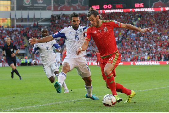 Gareth Bale right of Wales takes on an Israeli defender during European Championship qualifying on Sunday in Cardiff