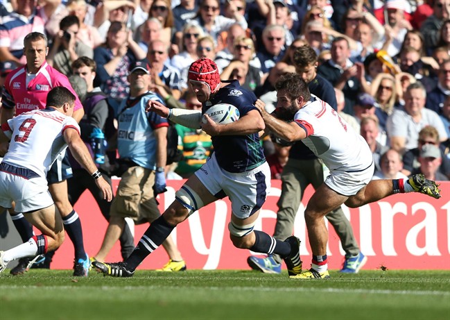 Scotland's Grant Gilchrist is tackled by Phil Thiel of the USA right during their Rugby World Cup Pool B match between Scotland and USA at Elland Road Leeds England Sunday Sept. 27 2015