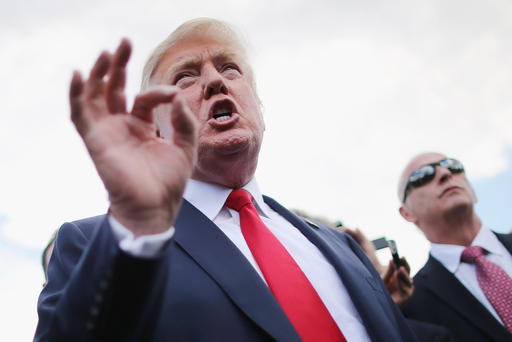 Republican presidential candidate Donald Trump talks with journalists during a rally on the West Lawn of the U.S. Capitol