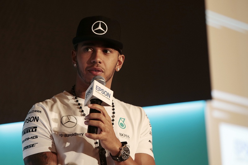 British Formula One driver Lewis Hamilton of Mercedes AMG Petronas racing team speaks to reporters during a Epson event in Singapore