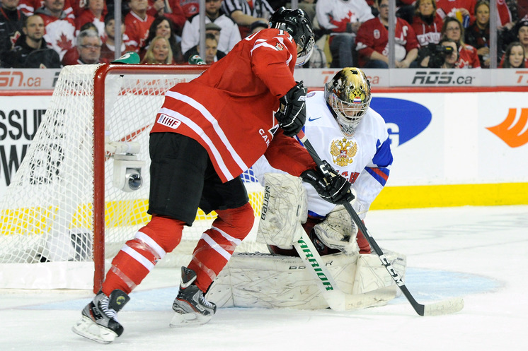 Andrei Vasilevski right of Team Russia stops the puck in front of Jonathan Huberdeau of Team Canada during the 2012 World Junior Hockey Championships in Calgary