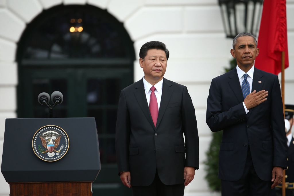 WASHINGTON DC- SEPTEMBER 25 U.S. President Barack Obama and Chinese President Xi Jinping listen to their national anthems during a state arrival ceremony on the south lawn of the White House grounds