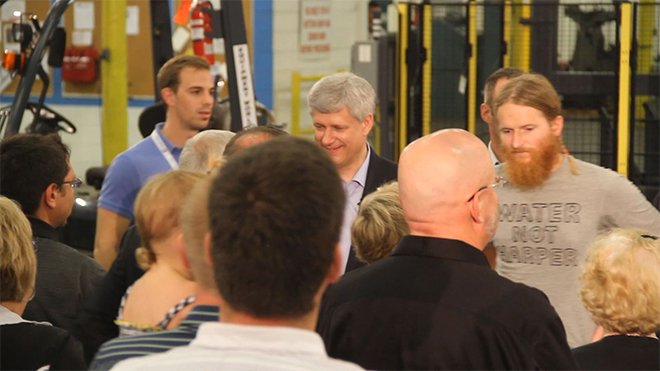 North Bay Environmentalist Yan Roberts slipped through security and stood next to Stephen Harper with a t-shirt stating'Water not Harper