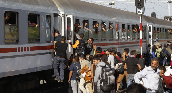 Migrants climb through windows to board trains at the train station in Beli Manastir near the Hungarian border on Friday in Beli Manastir Croatia