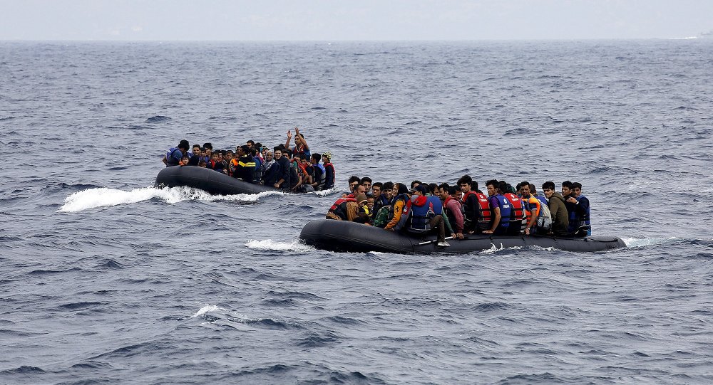 Syrian refugees and other migrants arrive at a beach on the Greek island of Lesbos in overcrowded dinghies after crossing a part of the Aegean Sea from the Turkish coast